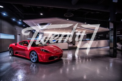 Glimpse of inside of the Twenty7 showroom with entertainment bar just behind the luxury vehicle (CNW Group/Twenty7 Social Club)