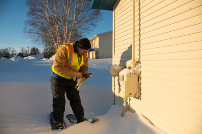 DTE Energy service tech. reads gas meter in Sault Ste. Marie, Mich.