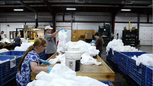Jackson County Developmental Center (JCDC) employees in Parkersburg, West Virginia work to remove zippers and other metal parts from protective garments so that the apparel can be recycled through The RightCycle Program by Kimberly-Clark Professional.