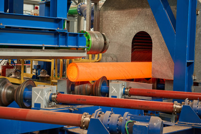 TimkenSteel’s advanced quench-and-temper facility provides 50,000 process tons of additional quench-and-temper capacity to improve delivery times of thermal-treated bars and tubes and meet strong market needs. Above, a 12.284-inch OD x 1.614-inch-wall seamless mechanical tube is shown entering the facility’s quench system.