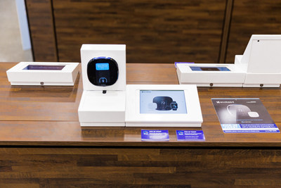 Products are displayed out of the box to encourage hands-on play and enhance product knowledge. iPads with product-related content and pricing details can be found alongside each device.