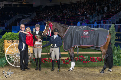 Jeff Brandmaier (left), Muffie Guthrie, and their daughter, Liza Jean, presented Erynn Ballard and Enchanted with the Lorna Jean Guthrie Challenge Trophy for the Canadian Hunter Derby Champion. Photo by Ben Radvanyi Photography (CNW Group/Royal Agricultural Winter Fair)