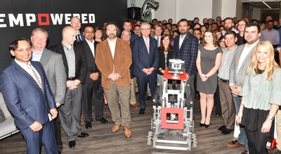 Empowered employees along with a robot created by grade school students from grades K-12 from Queen City Robotics take part in today's ribbon cutting ceremony for Empowered's new office space in Charlotte, NC.