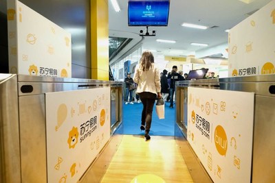 A customer walks through the self-service check-out area at the Suning unmanned store