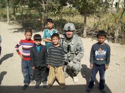 Army Captain (Sep.) Clint Byers, who received a Bronze Star, is pictured here with local children after completing a patrol in Kunduz, Afghanistan.