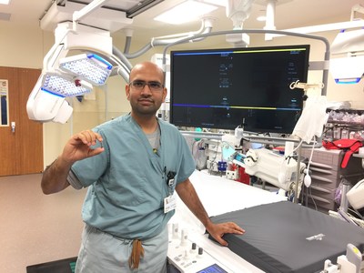 Dr. Rajesh Venkataraman in the cath lab at Houston Methodist The Woodlands Hospital, holding the world's smallest pacemaker