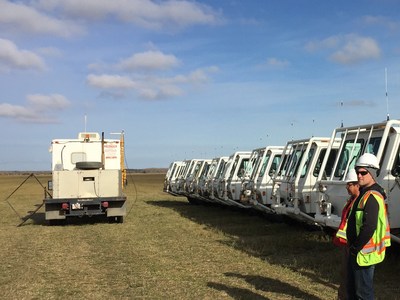 Fleet of seismic vibrators preparing for operations on Explor high density seismic project. (CNW Group/Explor)