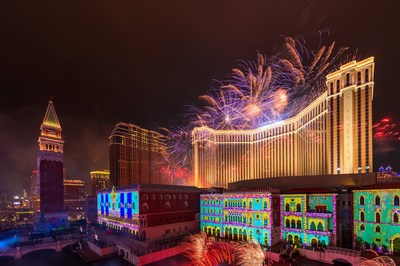 The Venetian Macao's façade is illuminated by 3-D mapping while the sky above is lit up by a pyrotechnic display Monday night at the integrated resort's 10th anniversary celebration.