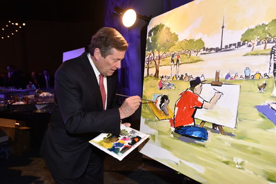 Mayor John Tory assists artist Peter Farmer in painting a Toronto park scene at tonight's Mayor's Evening for the Arts. The event raised money in support of Arts in the Parks, an initiative of the Toronto Arts Foundation that brings free arts programs to parks across Toronto. (CNW Group/Toronto Arts Foundation)