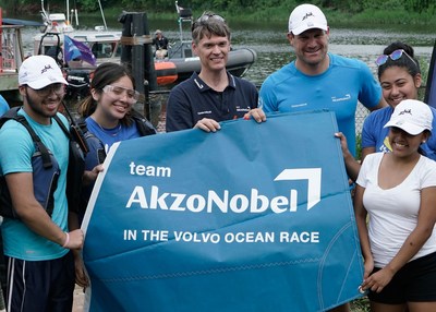Bill Collins, Group Controller for AkzoNobel's Paints & Coatings business (left) and Simeon Tienpont, Skipper of team AkzoNobel, present kids from Rocking the Boat with one of three sails AkzoNobel donated to the non-profit during a visit to Rocking the Boat in July 2017.