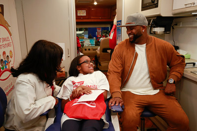 Baseball great C.C. Sabathia, right, listens as Colgate Bright Smiles, Bright Futures dental coordinator Dr. Dominique Juste, left, shares oral health tips with P.S. 129 student Reina Copeland, center, aboard the Colgate mobile dental van during the Greater New York Dental Meeting on Tuesday, Nov. 28, 2017 in New York. (Mark Von Holden/AP Images for Colgate Bright Smiles, Bright Futures)