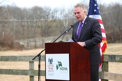 Virginia Gov. Terry McAuliffe speaking at a 12/6/2017 news conference to announce a new Virginia regional battlefield park, created by the Civil War Trust and NOVA Parks. In background: historic Goose Creek Bridge, constructed in 1802.