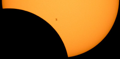 The International Space Station is seen in silhouette from Northern Cascades National Park in Washington as it transits the Sun at roughly five miles per second during a solar eclipse on Aug. 21, 2017. Photo Credit: NASA/Bill Ingalls