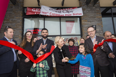 Salon owner Yasir Saeed, third from left, Fort Saskatchewan Mayor Gail Katchur, fourth from left, and COO Rob Goggins, second from right, cut the ribbon at the 150th Canadian Great Clips in Fort Saskatchewan, Alberta as attendees celebrate on Tuesday, December 12, 2017.  (Amber Bracken for CNW) (CNW Group/Great Clips, Inc.)