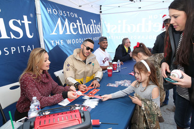 Houston Astros' shortstop Carlos Correa signs autographs for more than 200 fans at a toy drive.