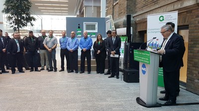 Hon. Chris Ballard, Minister of Environment and Climate Change announces details of the new low carbon program for Ontario, while industry advisors stand by. (CNW Group/Ontario Geothermal Association)