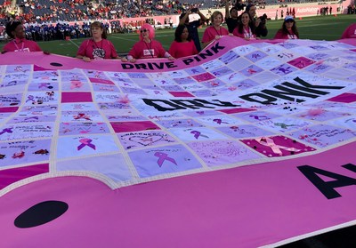 At half time, 15 brave cancer survivors led by AutoNation associate Karen Gelfer carried the 20 foot AutoNation DRIVE PINK Quilt, on to the field.