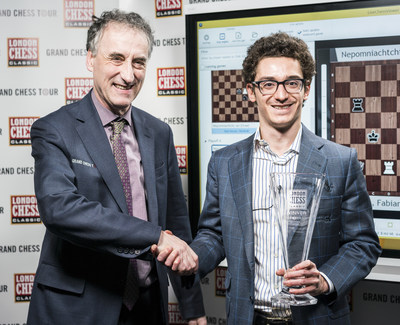 American Grandmaster Fabiano Caruana (right), the No. 2 rated player in the world, accepts the 2017 London Chess Classic trophy.
