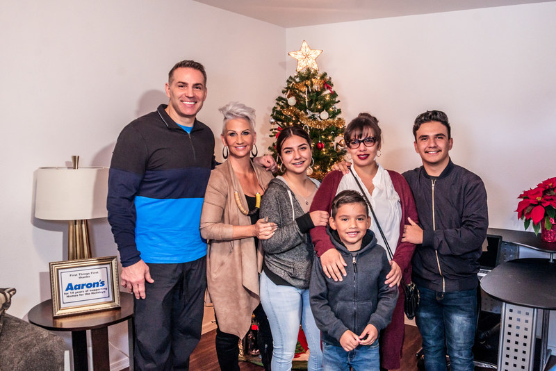 Aaron's, Inc., a leading omnichannel provider of lease-purchase solutions, and its divisions Aaron's and Progressive Leasing, contributed the furnishings for two surprise home presentations to Phoenix residents Julia Campos (and family pictured here) and Angelica Valentin last week as part of the “Homes for the Holidays” program sponsored by retired NFL quarterback Kurt Warner, his wife Brenda, their First Things First Foundation (FTFF) and Habitat for Humanity Central Arizona.