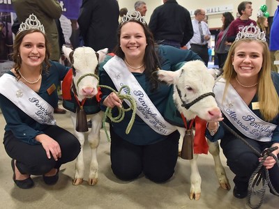 State Dairy Princesses (from left) Yvonne Longenecker of Blair County, Casandra Blickley of Chester County and Gretchen Little of Centre County pose with three-week old newborn calves “Fill” and “Hope” as dairy industry leaders joined today to announce the Calving Corner, a cow birthing center exhibit debuting at the PA Farm Show.