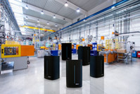 Horizontal image of huge new modern factory with robots and machines producing industrial plastic pieces and equipment. Wide angle view of futuristic machines standing on flooring and having the monopole of all work, taking the place of human work. There is not necessary use human hand. Wide angle, view, no people, space for copy.