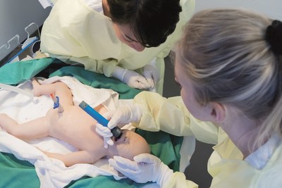 Learner practices intubation with SimNewB® while another learner observes.