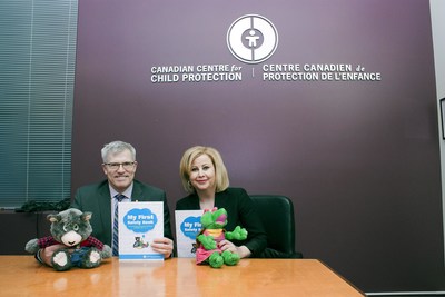 Commissioner Vince Hawkes, Ontario Provincial Police and Lianna McDonald, Executive Director for the Canadian Centre for Child Protection with puppets and My First Safety Book, a new safety tool that helps children aged four to seven develop personal safety skills. (CNW Group/Ontario Provincial Police)