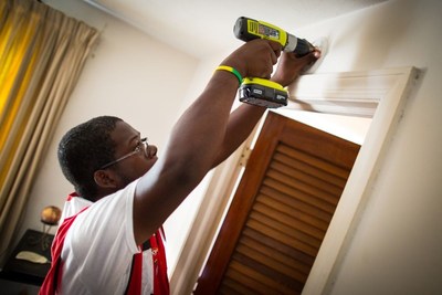 Patrick Smiley installing smoke alarm mounting ring. With staff and volunteers, the American Red Cross canvassed the community with fire safety materials and installed smoke alarms in under-served/military connected neighborhoods around the Fort Bragg area in Fayetteville, North Carolina, with a goal of installing 1500 smoke alarms. Photo by Adam Jennings/American Red Cross.