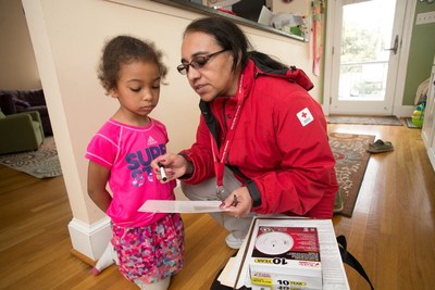 The American Red Cross works with the Arlington Fire Department to distribute free smoke alarms and fire education to area residents. Photos by Dennis Drenner for the American Red Cross