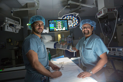 Henry Ford Allegiance Health neurosurgeons Azam Basheer, MD, (left) and Amritraj Loganathan, MD, with the ExcelciusGPS robot.