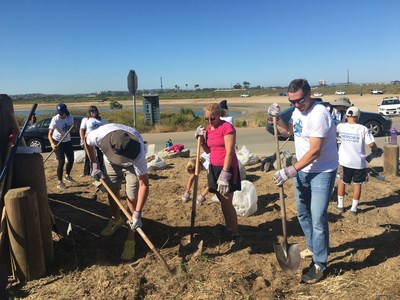 Volunteers at one of Bridgepoint Education's annual volunteer events, including CEO Andrew Clark (right), help enhance the Fiesta Island Youth Camp in San Diego.