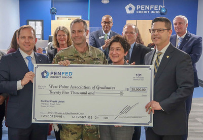 PenFed Credit Union President and CEO James Schenck (left) presents a $25,000 donation check to the West Point Association of Graduates' Cyber Research Center. He is joined by West Point Garrison Commander Col. Andrew S. Hanson, Deputy Director of the Cyber Research Center Susan Schwartz, President and CEO for the Association of Graduates at West Point Todd Browne, and other PenFed executives.