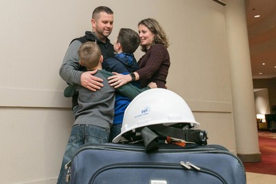 PPL Journeyman Lineman Jason Roberts of Lackawanna County shares a moment with his family before leaving for a month of power restoration work in Puerto Rico.