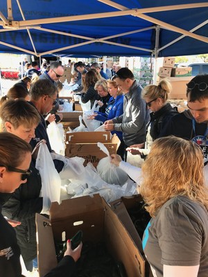 Farmers Insurance executives, employees, agents and district managers participate in the annual Neighborhood Food Exchange to help provide local military families with food and supplies.