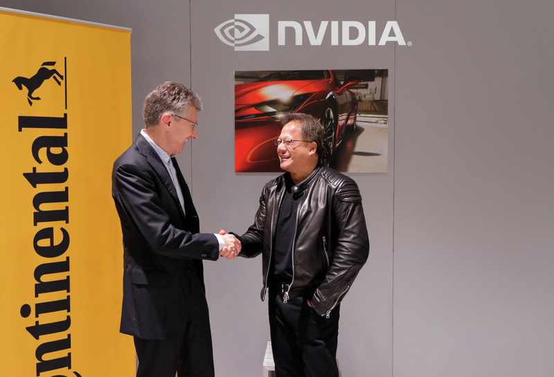 Continental CEO Dr. Elmar Degenhart shakes hands with founder and NVIDIA CEO Jensen Huang.