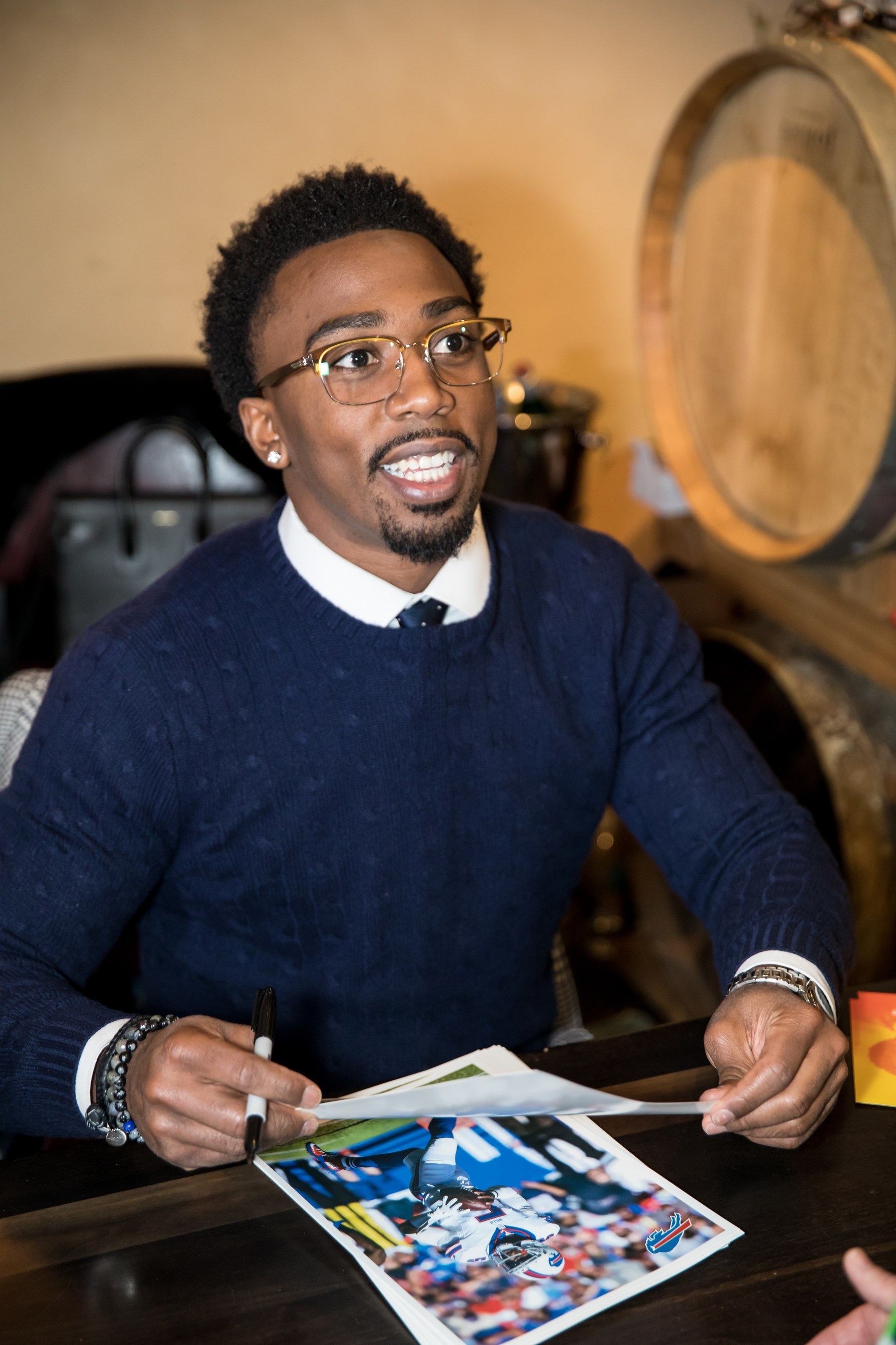 Tyrod Taylor signing autographs at the recent FrameGenie T2 launch party.