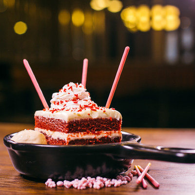 TGI Fridays collaborates with Pocky on Red Velvet Sparkler Cake, a decadent new dessert sensation that's getting rave reviews on social media platforms. Served table side with sparklers, the dessert features red velvet cake, layered with cream cheese frosting and red and white sprinkles. It's served in a bowl of strawberry fizz candy clusters and a scoop of vanilla ice cream, and topped off with Strawberry Pocky. The Red Velvet Sparkler Cake is available at all TGI Fridays locations.