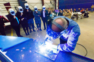 A welder authenticates the keel of LCS 21, the future USS Minneapolis-Saint Paul, by welding the initials of ship sponsor Jodi J. Greene. The Keel Laying is the formal recognition of the start of the ship's module construction process.