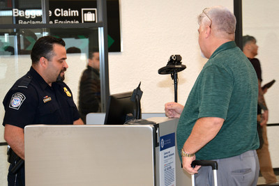 A passenger is screened with new facial recognition passport screening technology.