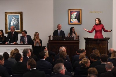 Helena Newman, Chairman of Sotheby’s Europe, fields bids during the Impressionist & Modern Art Evening sale in London on 28 February 2018  - part of a two week series of auctions that raised more than $430 million and saw Pablo Picasso’s portrait of Marie-Thérèse Walter sell for nearly $70 million.