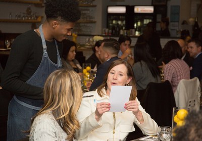 A BBVA Compass guest places her order with a Café Momentum intern Thursday night at the bank's event to celebrate the restaurant's founder, Chad Houser, who won the first-place prize of $50,000 in the BBVA Momentum accelerator program for social entrepreneurs.