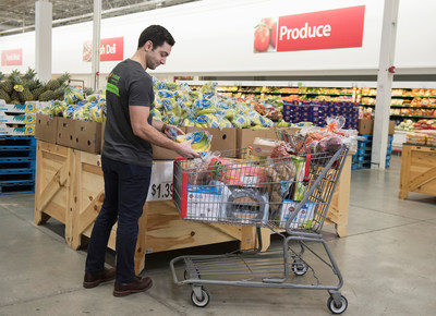 An Instacart employee selects fresh produce at BJ’s Wholesale Club in Waltham, Mass. on March 13, 2018 for same-day delivery to BJ’s members as part of the companies’ expanded partnership. (BJ’s Wholesale Club/Christine Hochkeppel)