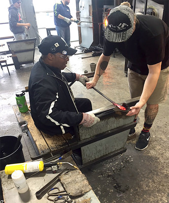 A wounded warrior receives instructions for making his own unique artwork during a recent WWP glassblowing class in Hollywood, Florida.