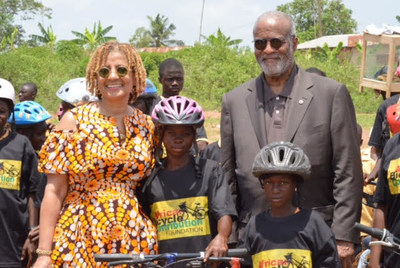 ABCF Executive Director Patricia Marshall Harris (left) and board chair A.Bruce Crawley (right) are shown, post-bike distribution ceremony, in Ejisu, Ashanti Region, Ghana with two helmeted bamboo bike recipients.