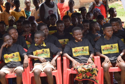 Students from Ejisu-Juabeng School, in the Ashanti Region of Ghana sit prior to a well-attended ceremony in which they received free EcoRide bamboo bikes funded by the African Bicycle Contribution Foundation.
