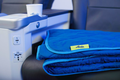 It’s the little extras of First Class that make all the difference. Alaska Airlines is adding cozy quilted throws on longer flights to keep you comfy.