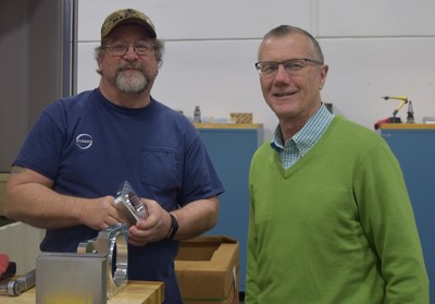 Ernie Hamm, machinist, is shown with Peter Feil, general manager.