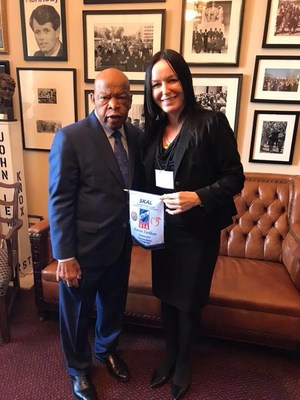 Burcin Turkkan presenting SKAL USA President 2018 souvenir banner to Congressman John Lewis.