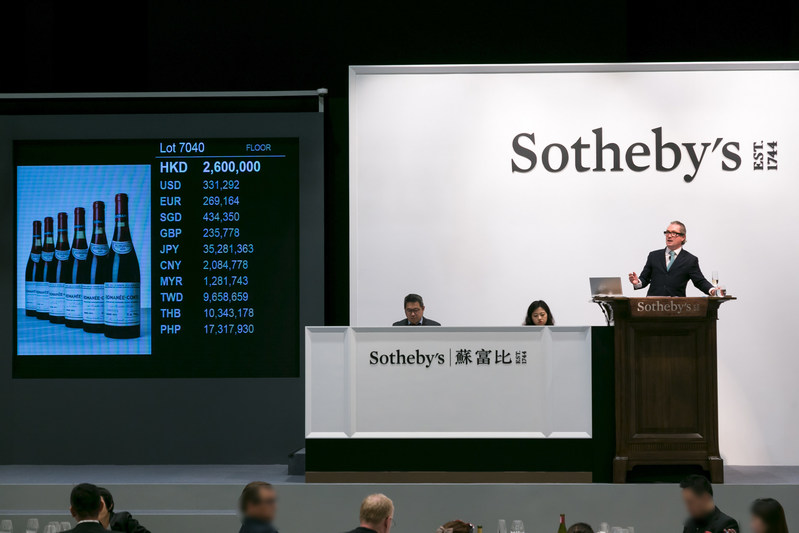 Sotheby's auctioneer Jamie Ritchie sells the top lot of the sales, 12 bottles of 1971 Domaine de la Romanée-Conti HK$3,198,000 / US$407,489