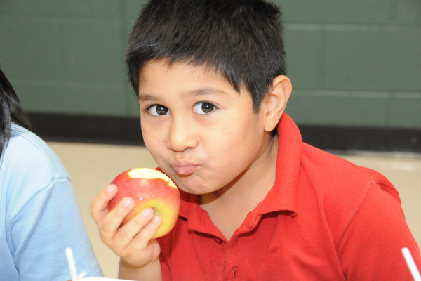 Picture of a student eating an apple 